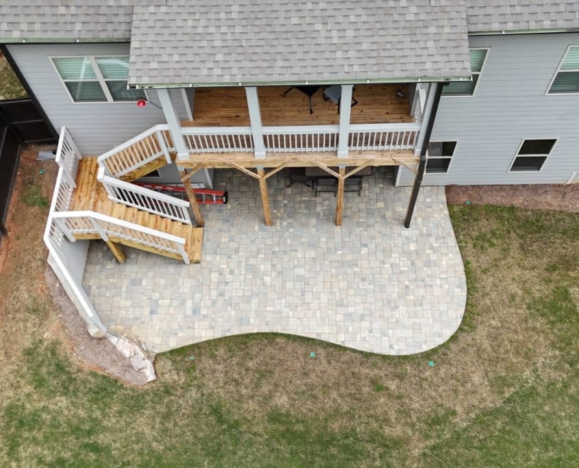 backyard patio under deck with retaining wall